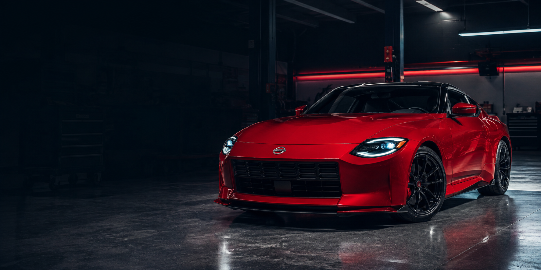 Red Nissan Z in a performance workshop