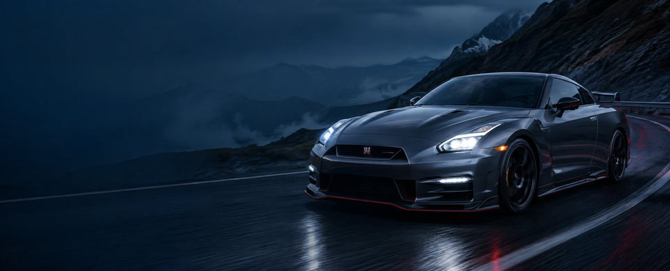 Nissan GT-R driving on a mountain road at dusk